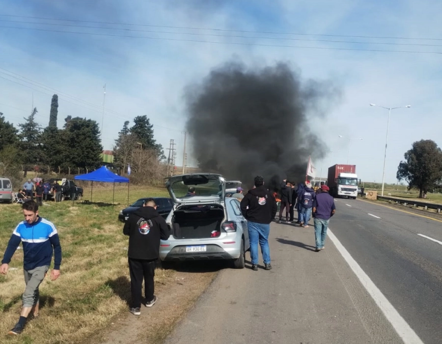 alt="Manifestantes congregados al costado de la ruta con quema de neumáticos y humo denso en el marco de la protesta en la Autovía 14"