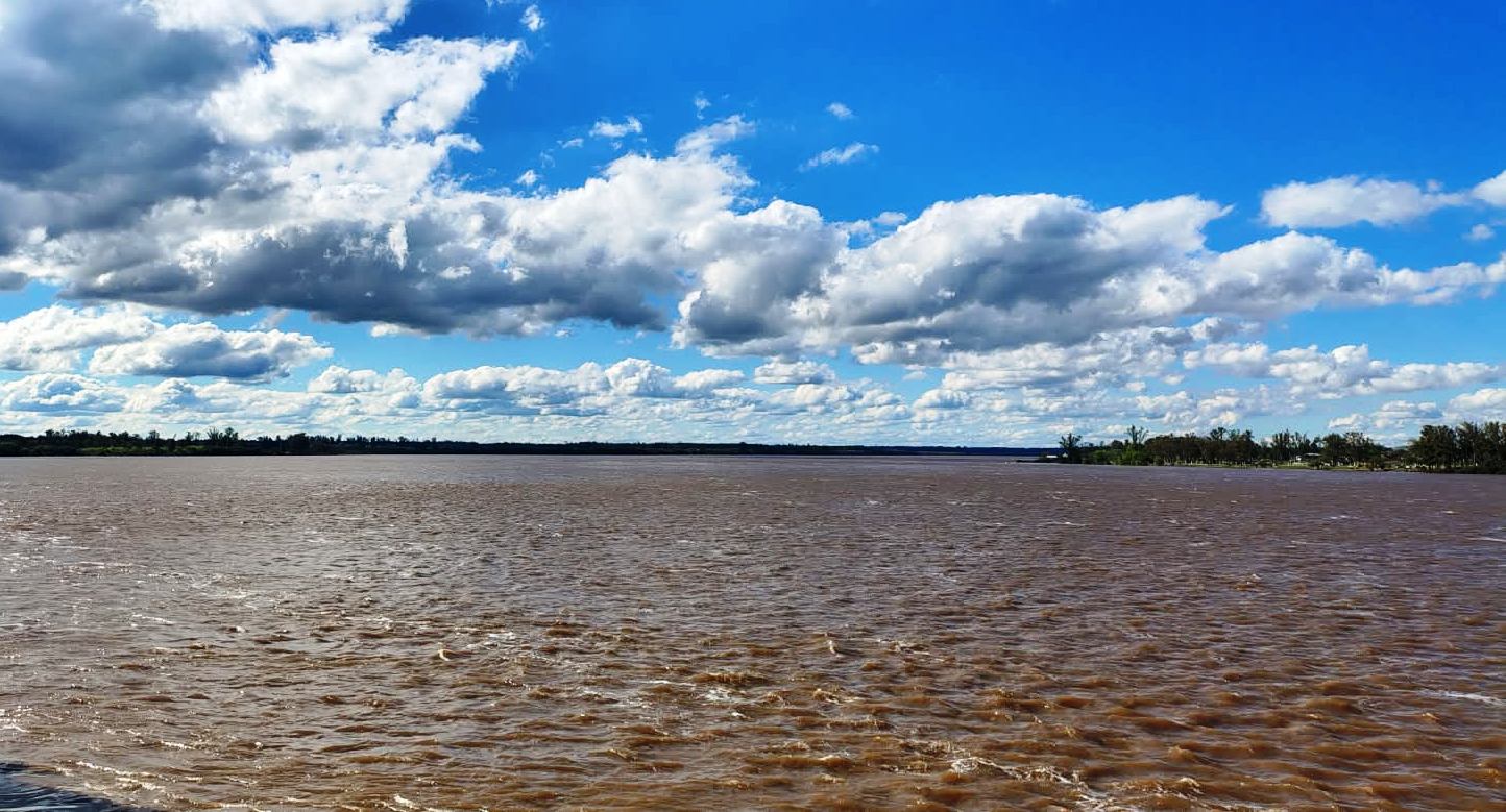alt="Creciente del río Uruguay en Concordia: aguas marrones y crecidas avanzan sobre la costa frente a la ciudad"